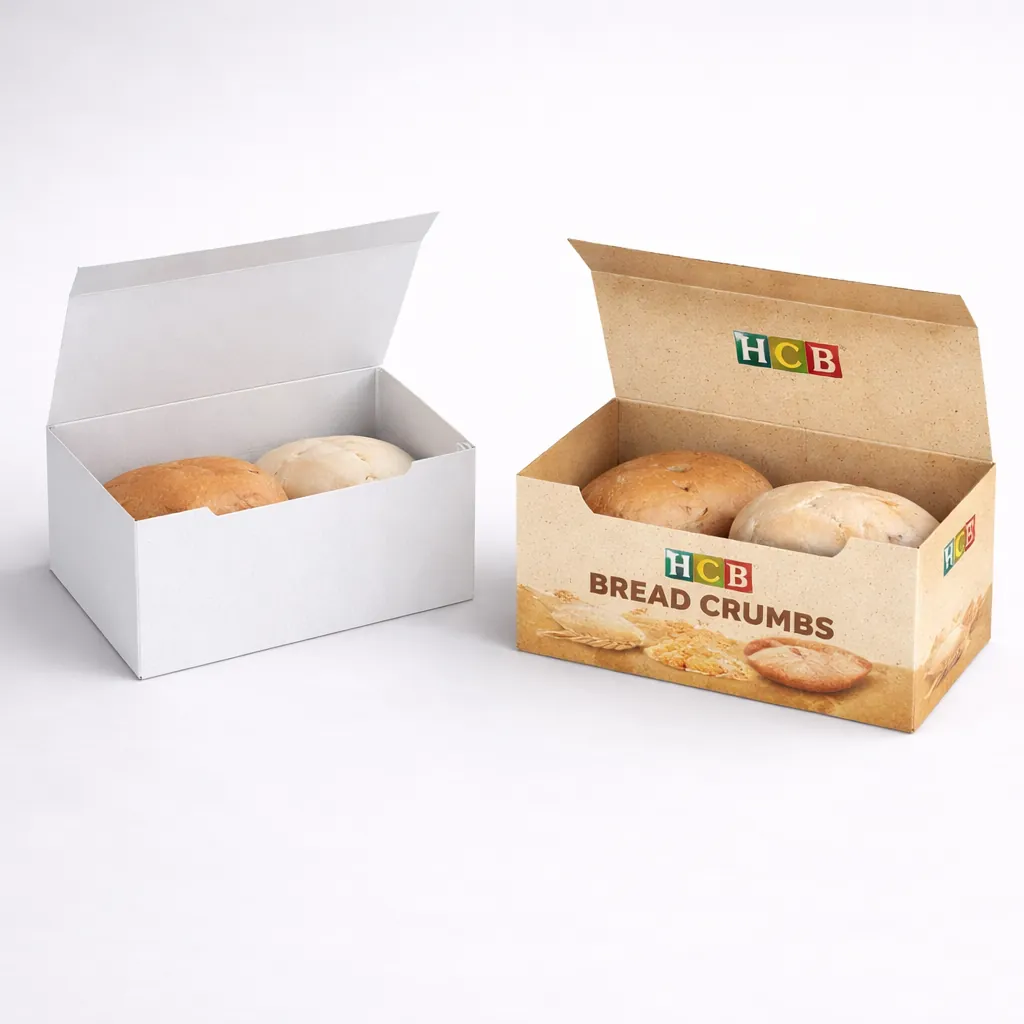 Two open rectangular boxes containing fresh bread rolls, one plain white and one with decorative wheat illustrations. class=